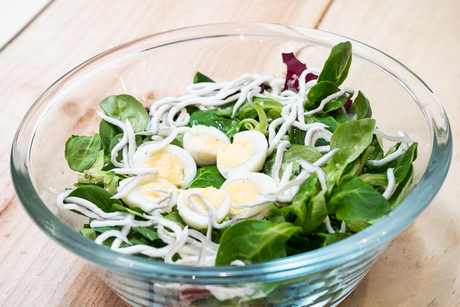 Salad with gulas and quail egg