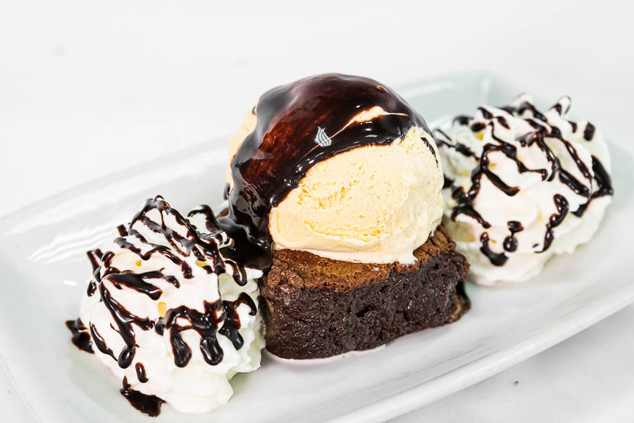 Brownie con chocolate templado y helado de vainilla y nata