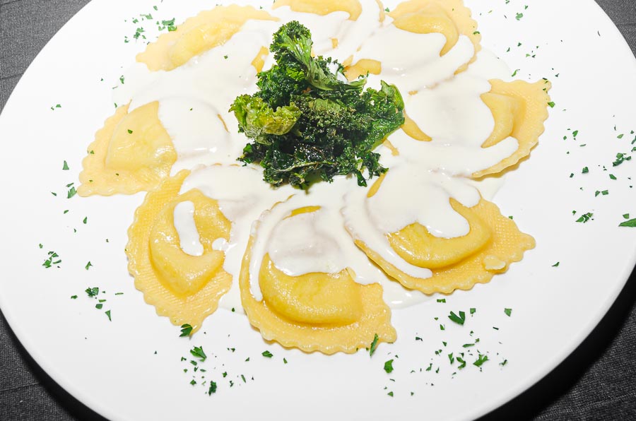 Ravioli filled with goat cheese and fig , serve with cheese and thyme cream