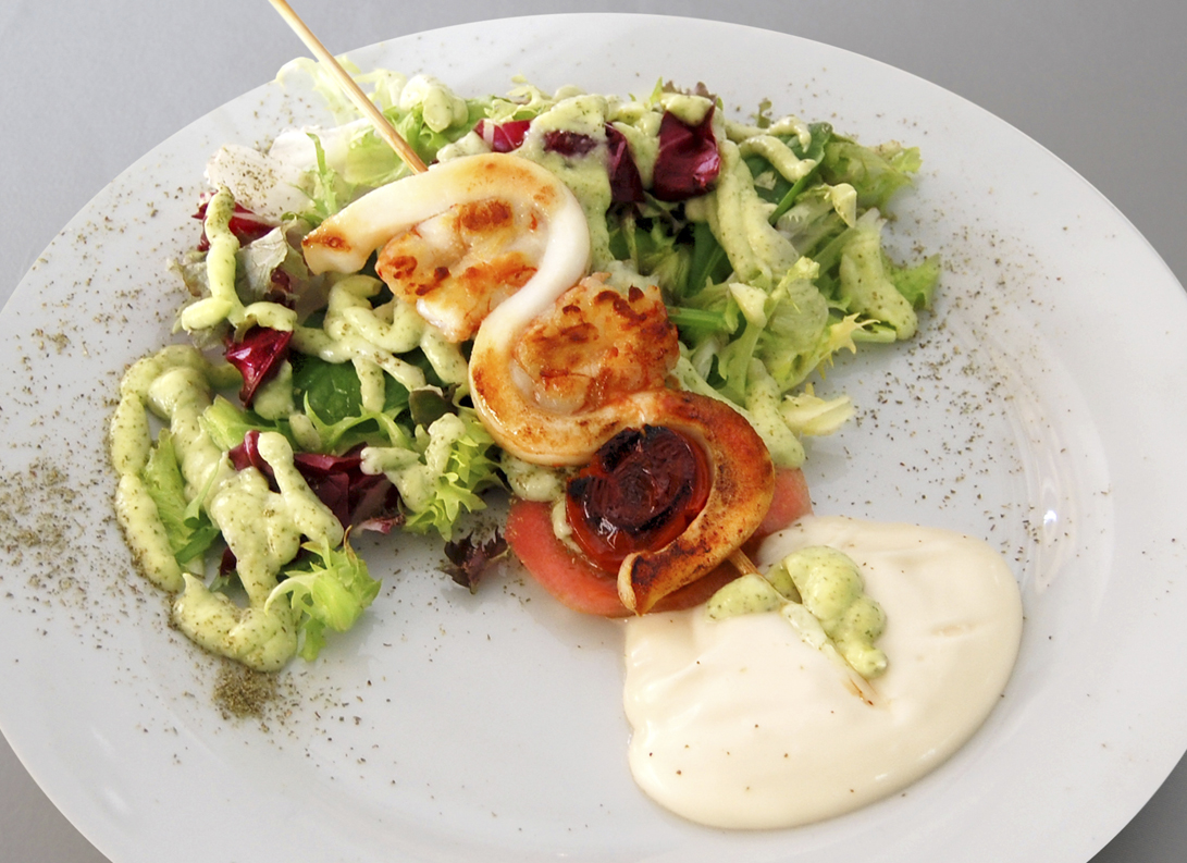 Squid skewer with prawns and salad.