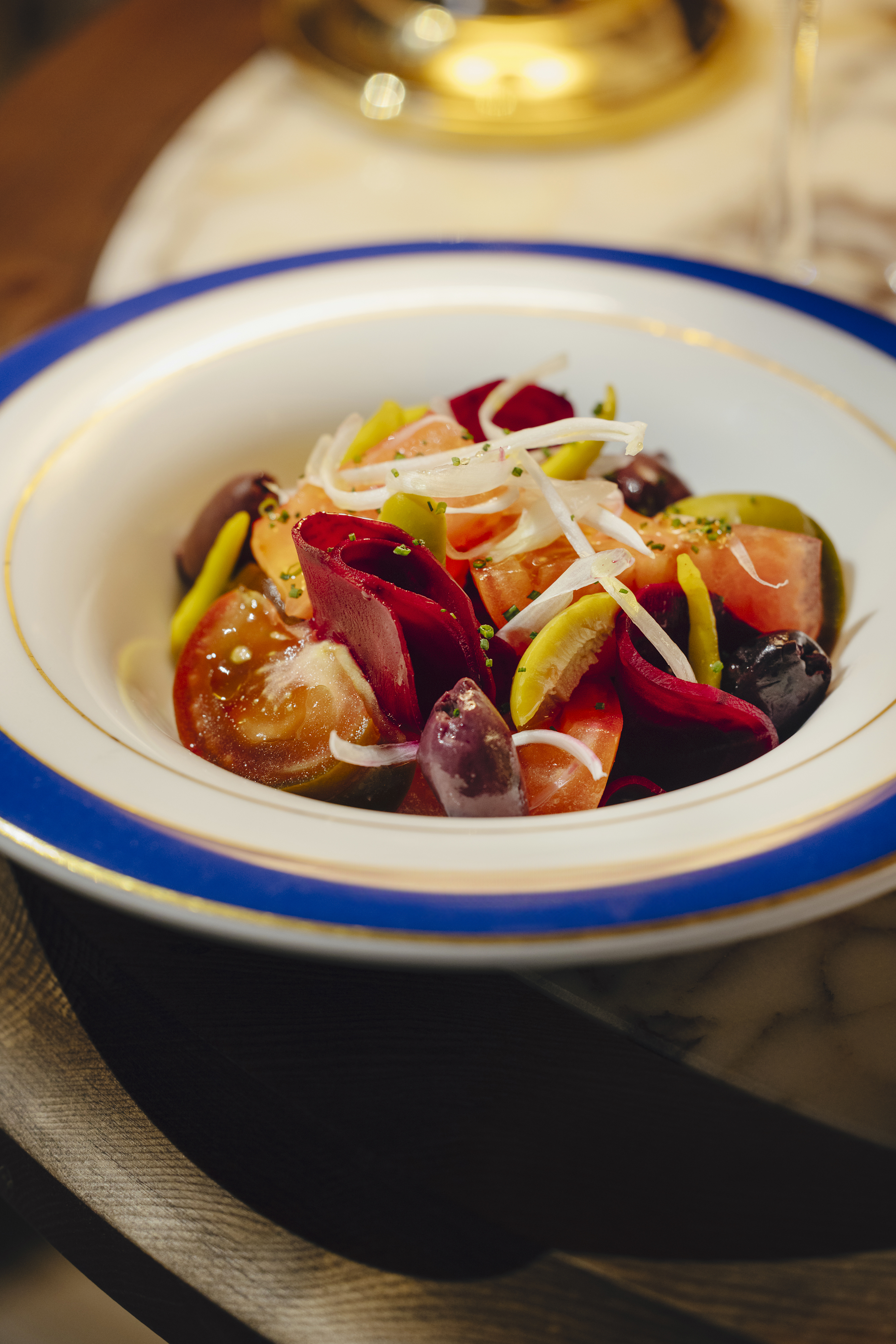Dressing of tomatoes with Kalamata olives, spring onions and pickles
