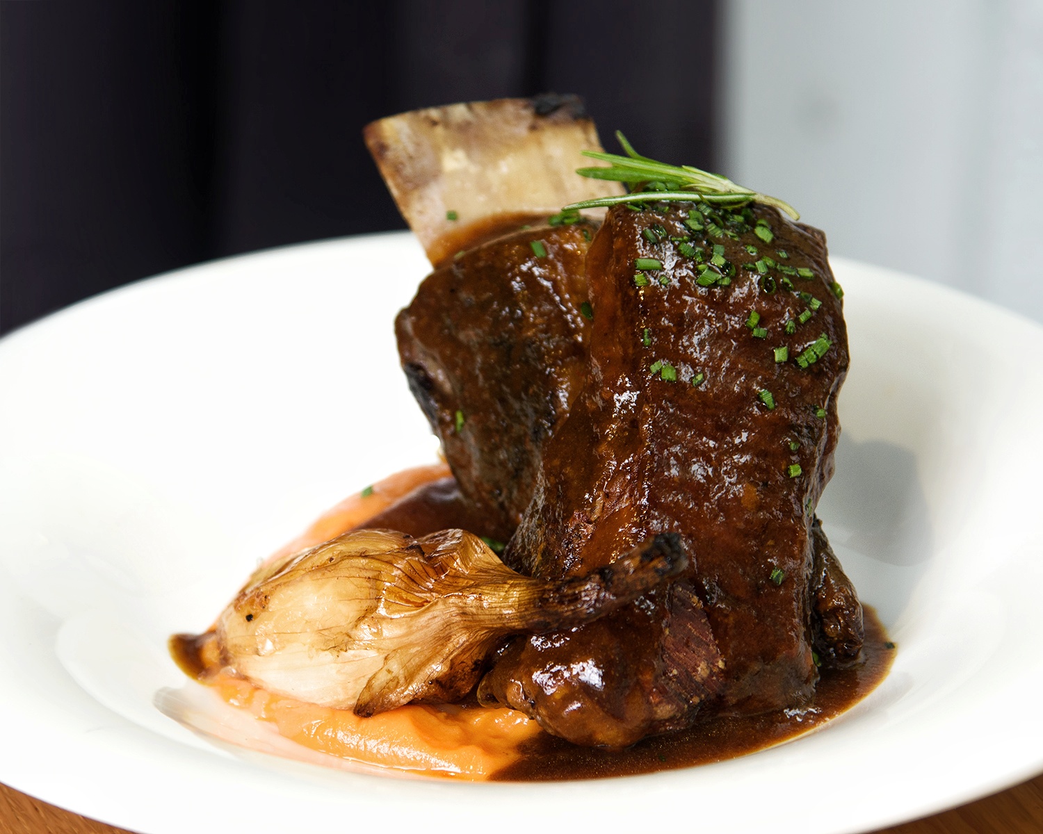 Rib de vaca glaseada a baja temperatura con puré de boniato y cebolleta asada