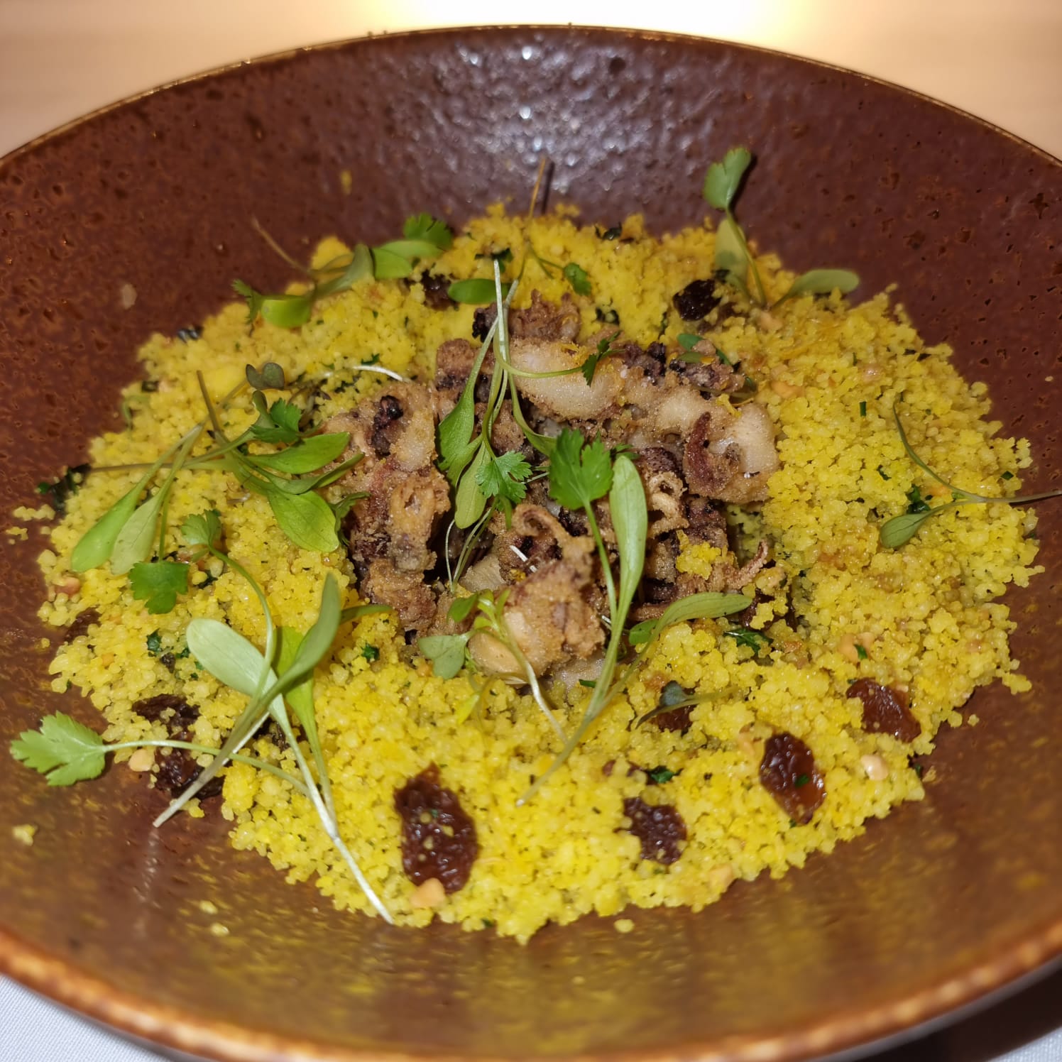 Fried small squid, citrus couscous, herbs and nuts