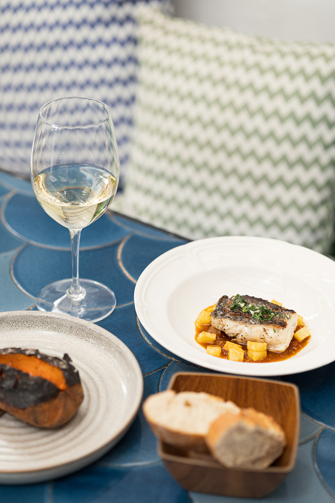 Grilled sea bass with seafood sauce and potatoes