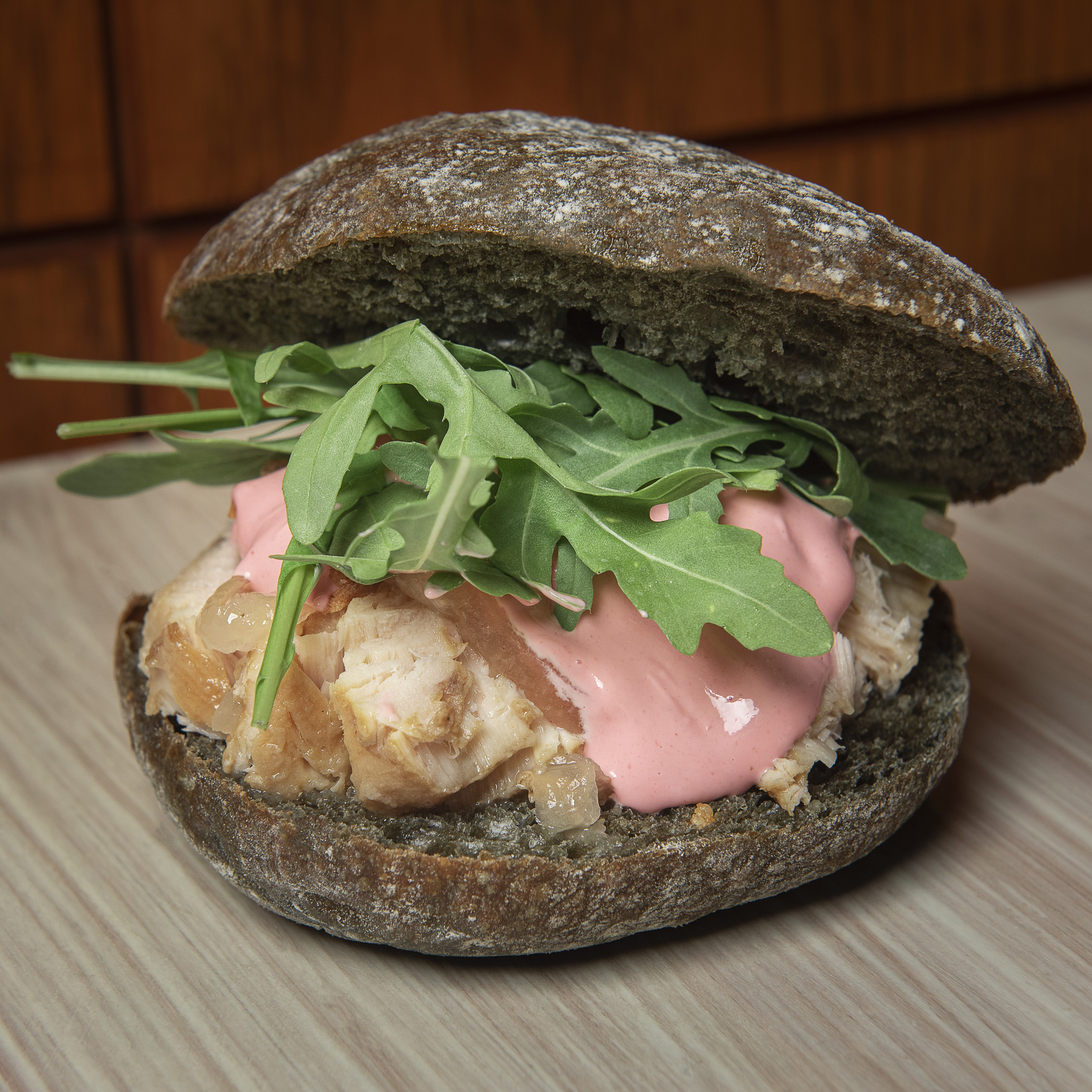 Pickled tuna sandwich with beet mayonnaise and arugula