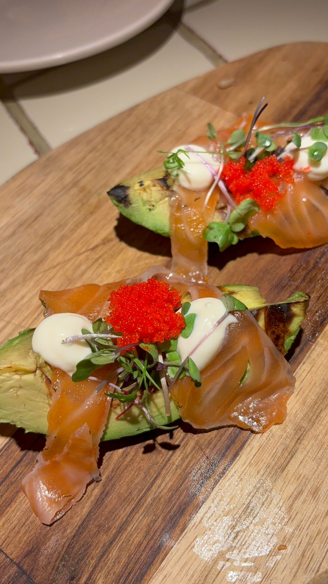 Grilled avocado with marinated salmon and cream cheese