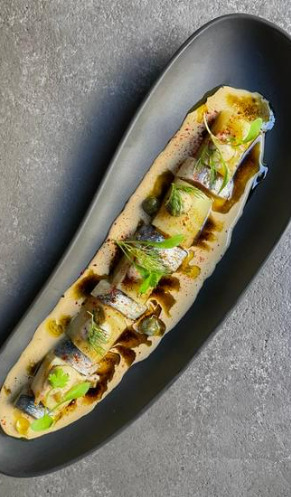 Puerro asado a la brasa, almendra, limón y botarga