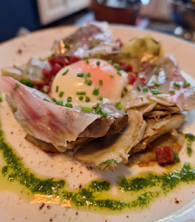 삶은 계란과 이베리아 햄을 곁들인 천연 콩피 아티초크.