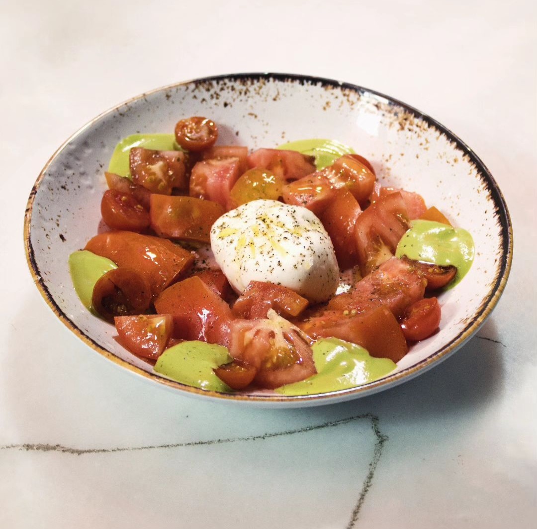 Tomato seasoned with chives and basil oil