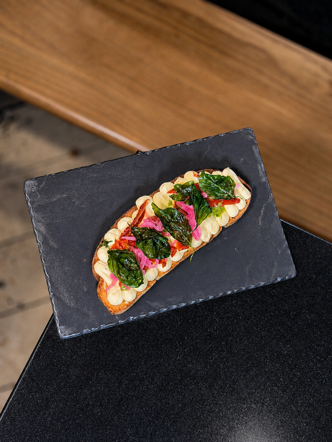 Toasted bread with hummus and confit tomato