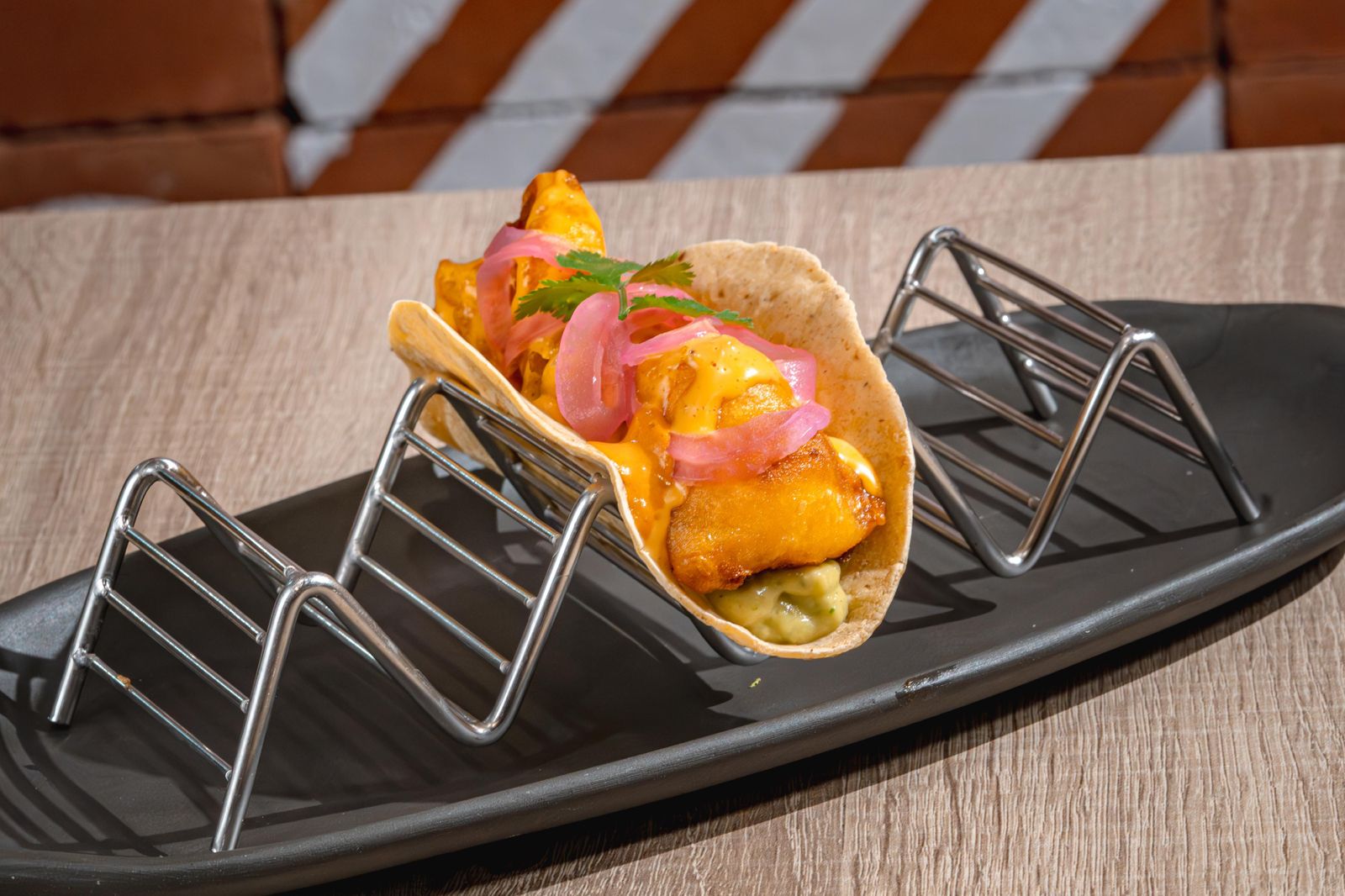 Tempura salmon taco with guacamole, kimchi and pickled red onion