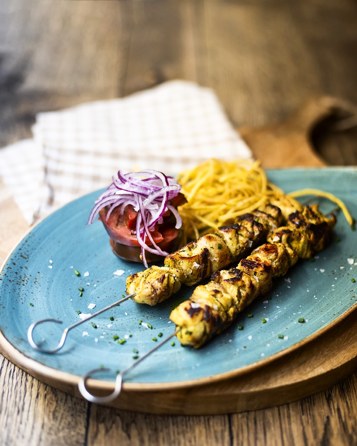 Brochetas de pollo moruno con patatas y tomate aliñado