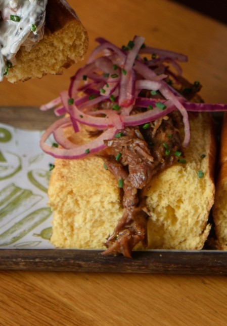 Pork cheek brioche with pickled onion