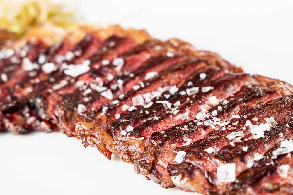 Grilled T-bone steak with butter and herbs