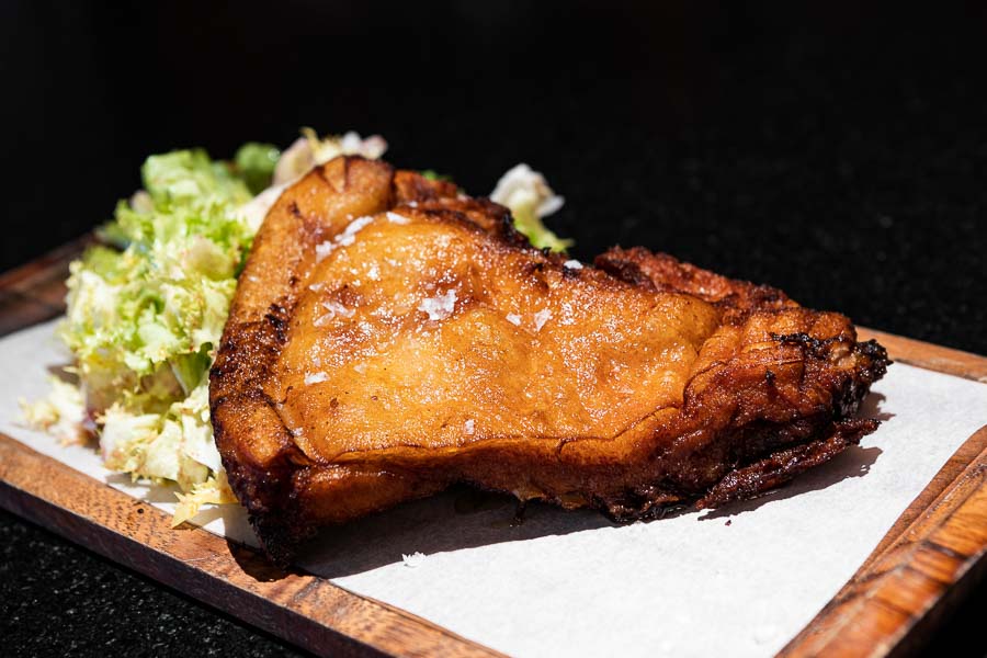 Old-fashion roasted suckling pig with endive salad and blue berry vinaigrette