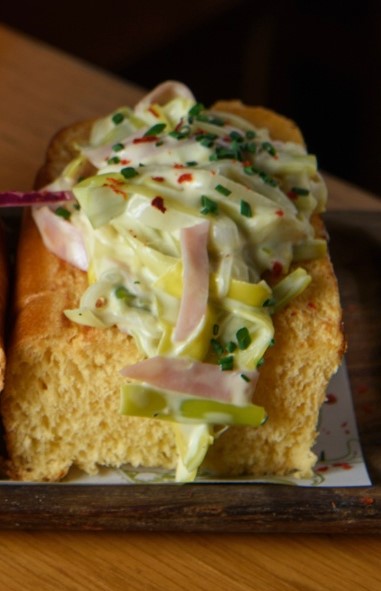 Leek, spring onion and ham salad in brioche bread with mayonnaise and mustard