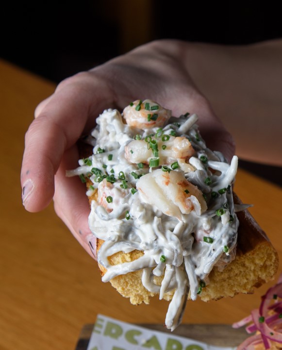 Baby eel and king prawn skewer with ali-oli on brioche bread