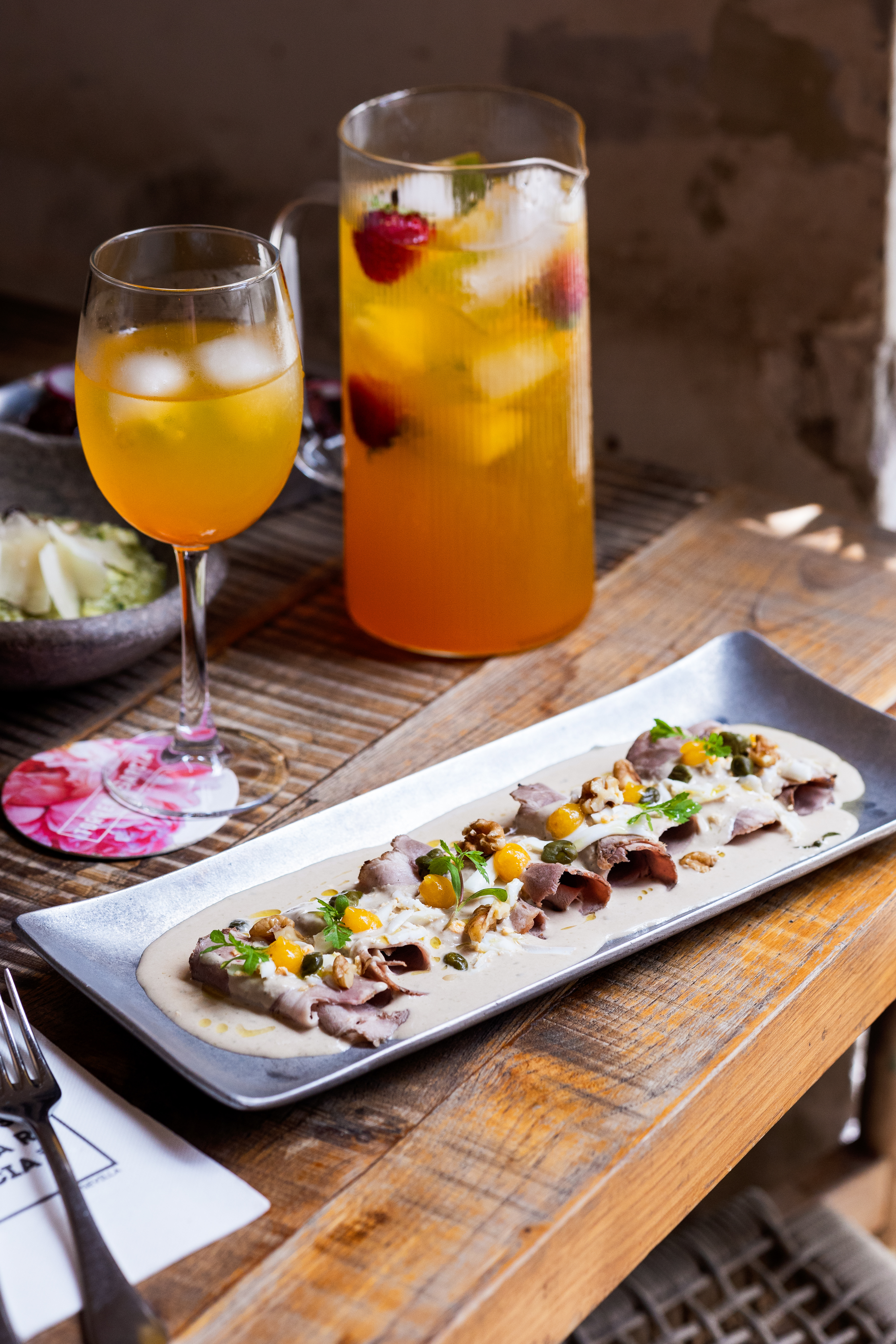 Vitelo tonnato. Thin slices of pork loin, apricot puree, walnuts, and capers.